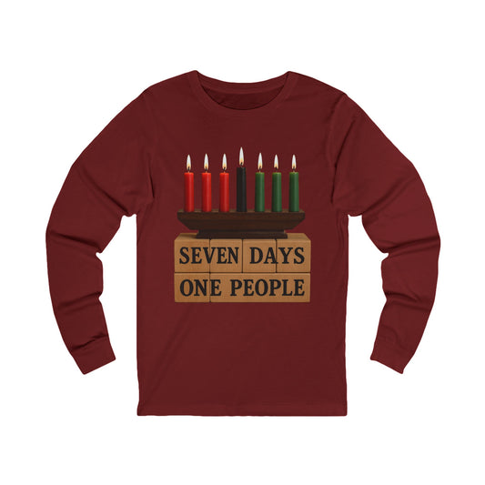 A maroon long-sleeve t-shirt with a graphic of a menorah on top of wooden blocks that read 'SEVEN DAYS ONE PEOPLE', set against a plain white background.