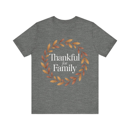 A heather gray short-sleeve t-shirt with a circular autumn leaf wreath graphic and the text 'Thankful for Family' printed on the chest, displayed against a solid white background.