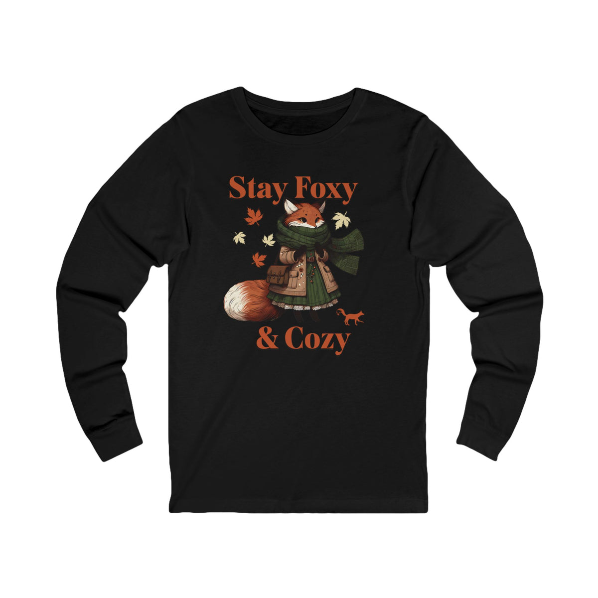 A black long-sleeve t-shirt with a cozy autumn-themed graphic of a fox in a green scarf and coat, surrounded by leaves, with the text 'Stay Foxy & Cozy' in orange.