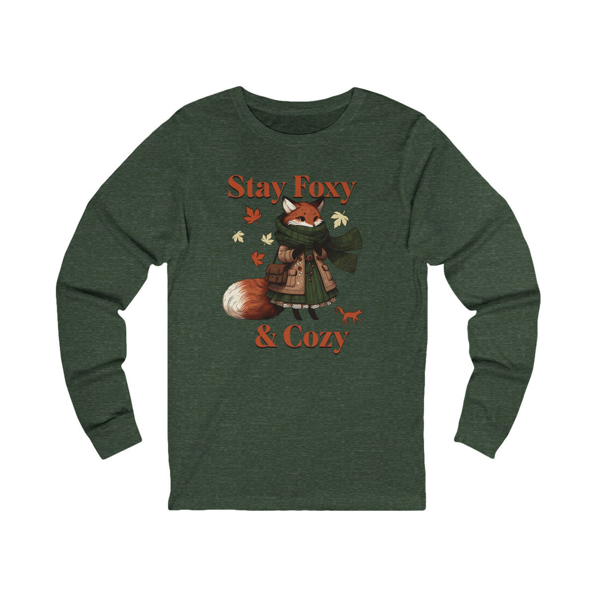 A dark heather green long-sleeve t-shirt featuring a graphic of a cozy fox wearing a green scarf and brown coat, surrounded by autumn leaves, with the text 'Stay Foxy & Cozy' in orange.