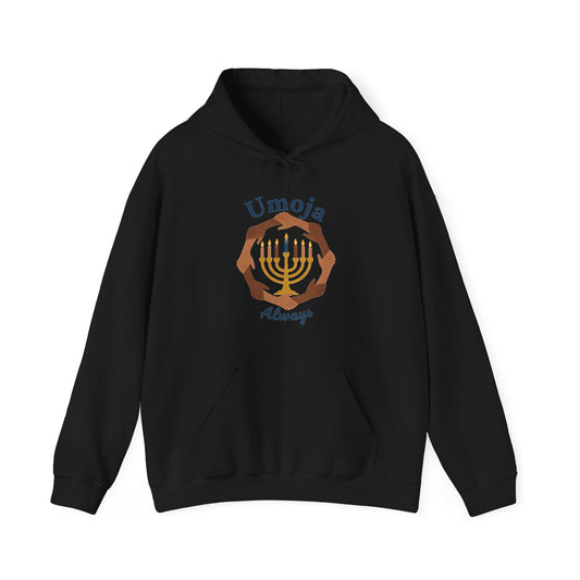 A black hoodie with a 'Umoja Always' graphic featuring a menorah and hands against a plain white background.