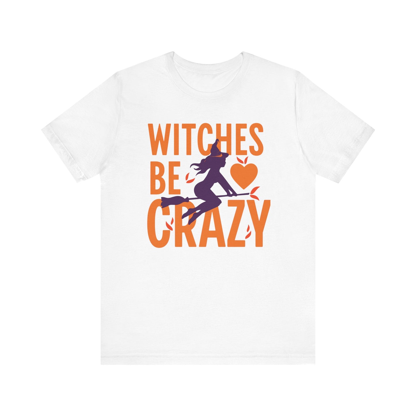 A white short-sleeve crewneck t-shirt featuring a Halloween graphic on the front with the text 'WITCHES BE CRAZY' in orange and a purple witch riding a broomstick with an orange heart.
