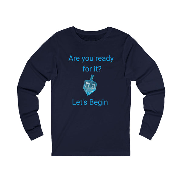A navy blue long-sleeve t-shirt with a light blue graphic on the front that reads 'Are you ready for it? Let's Begin' with a dreidel illustration, shown on a plain white background.