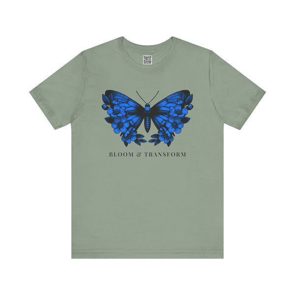 Sage t-shirt with a blue butterfly graphic and 'Bloom & Transform' text on a white background