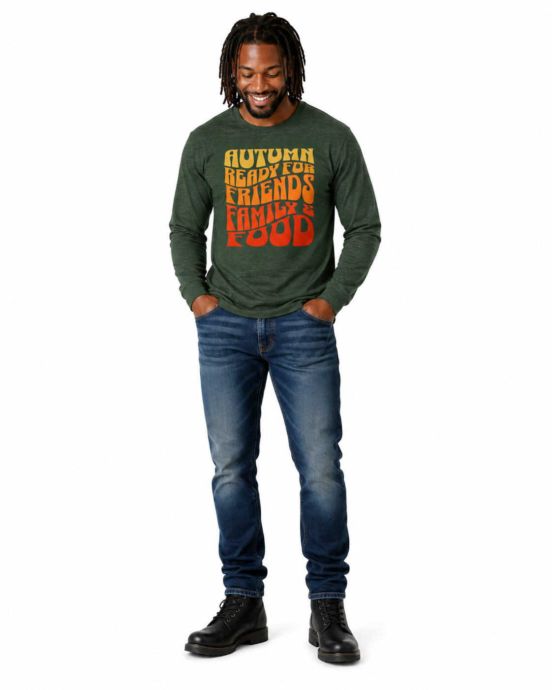 A man wearing a dark green long-sleeve t-shirt with a colorful 'Autumn Ready for Friends Family Food' graphic, paired with blue jeans and black boots, standing against a white background.