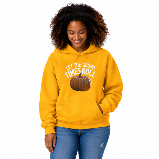 A woman with curly hair wearing a bright yellow hoodie with a pumpkin graphic and the text 'LET THE GOUD TIMES ROLL' on the front, paired with blue jeans, against a plain white background.
