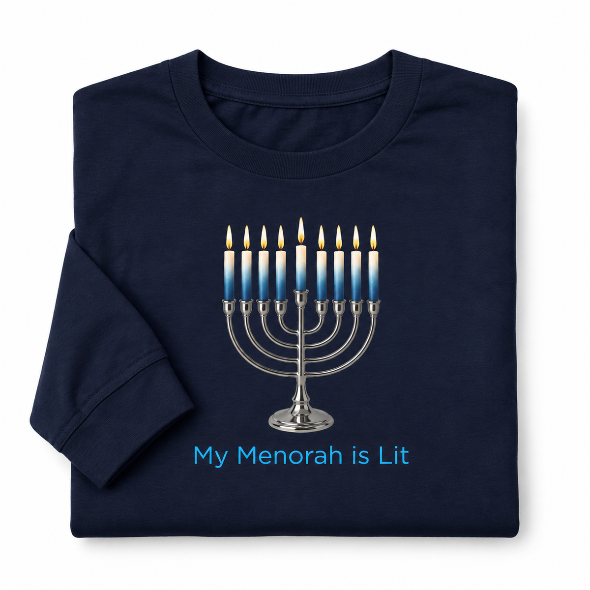 A navy blue folded long-sleeve t-shirt featuring a printed graphic of a lit silver menorah with blue-and-white candles and the text 'My Menorah is Lit' in light blue below it, shown on a plain white background.