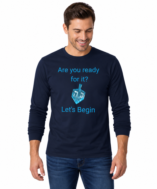 A man wearing a navy blue long-sleeve t-shirt with a blue graphic of a dreidel and the text 'Are you ready for it? Let's Begin' on a white background.