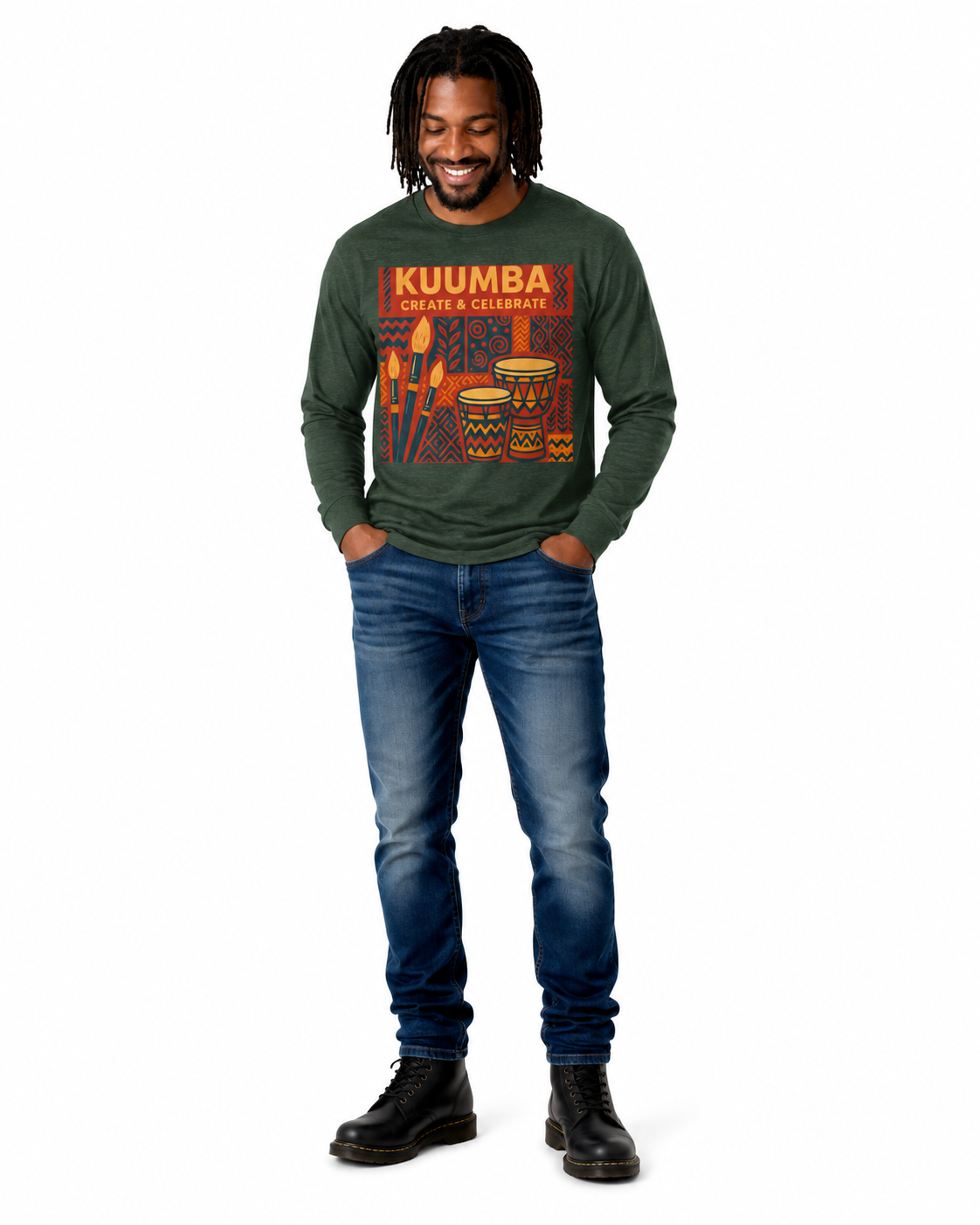 A man wearing a dark green long-sleeve graphic t-shirt with 'KUUMBA DRUM & DRUMMER' printed on the front, paired with blue jeans and black boots, standing against a plain white background.