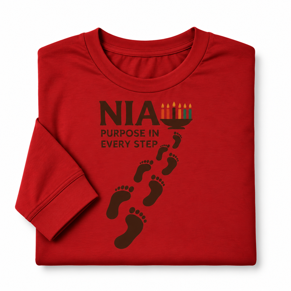 A folded red long-sleeve t-shirt with a black graphic print that reads 'NIA PURPOSE IN EVERY STEP' alongside footprints and a menorah illustration, shown on a plain white background.
