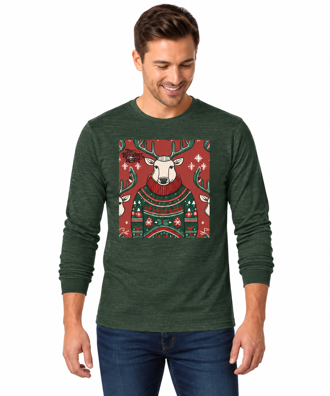 A man wearing a dark green long-sleeve t-shirt with a festive Christmas graphic of a reindeer in a sweater, paired with blue jeans, against a plain white background.