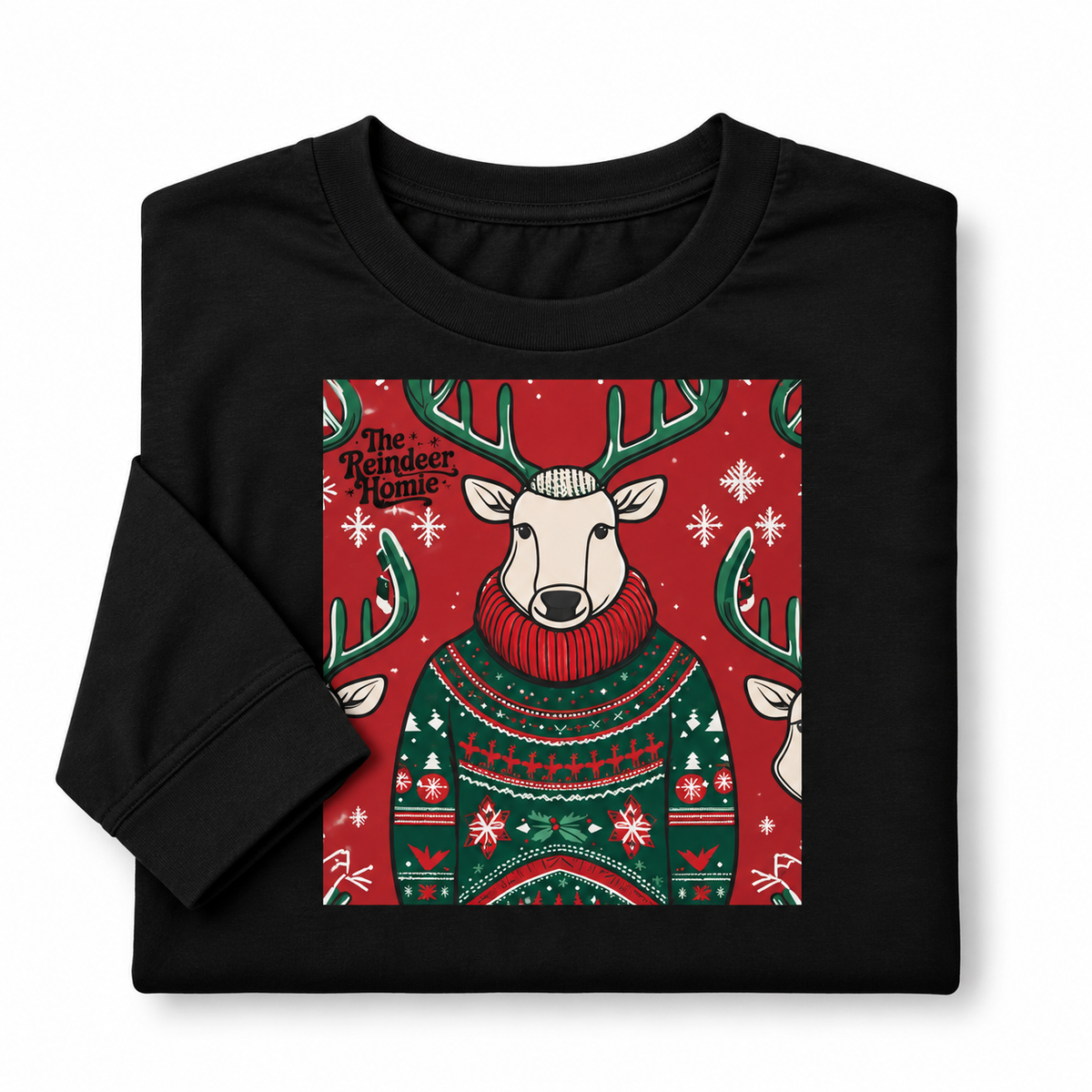 A folded black long-sleeve t-shirt with a festive graphic print of a reindeer wearing a green and red Christmas sweater on a red background, with the text 'The Reindeer Home' visible.