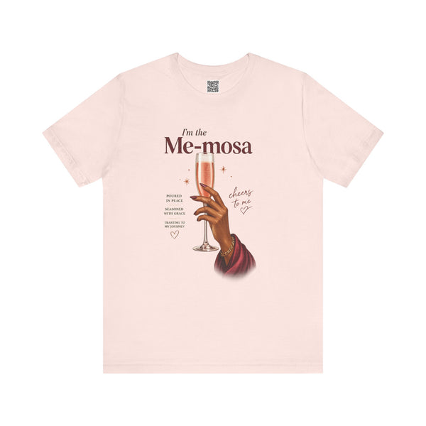 Soft pink t-shirt with a graphic of a hand holding a glass of mimosas and text on a white background