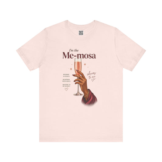Soft pink t-shirt with a graphic of a hand holding a glass of mimosas and text on a white background