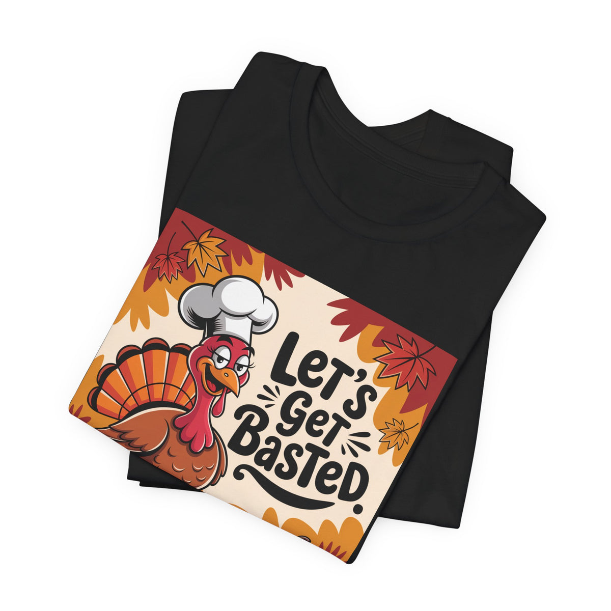 A folded black t-shirt with a colorful graphic print featuring a cartoon turkey chef and the text 'Let's Get Basted.' on a white background.