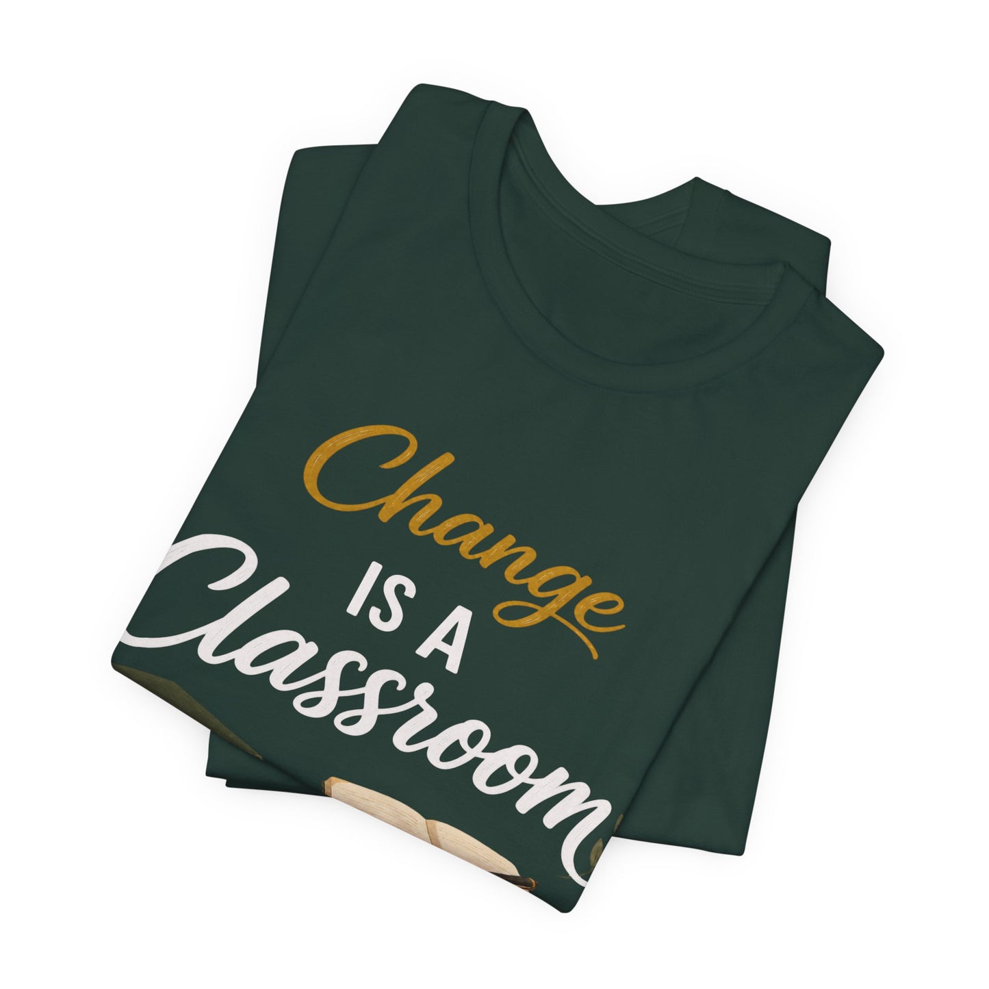 A dark green folded t-shirt with the text 'Change IS A Classroom' printed on the front in white and gold lettering, set against a plain white background.