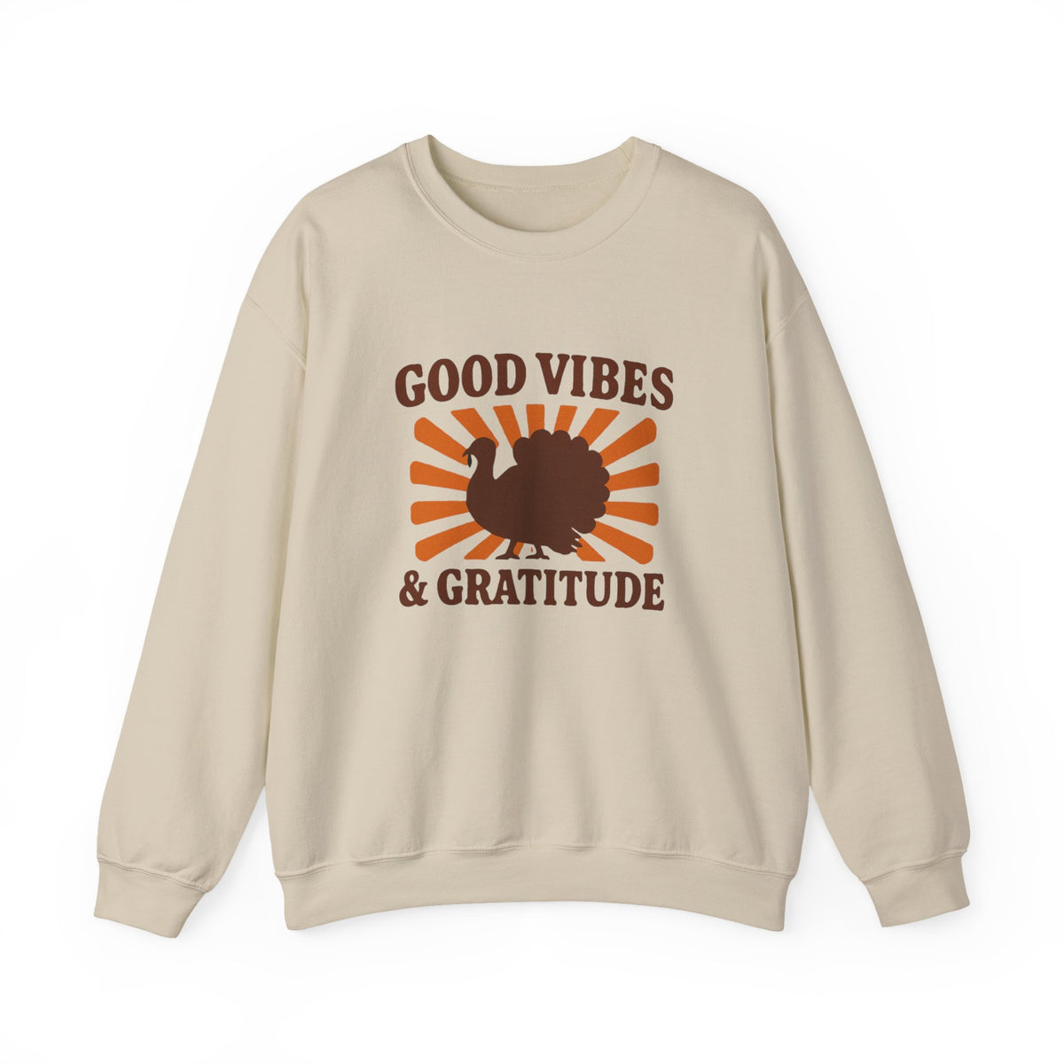 A beige crewneck sweatshirt featuring a 'Good Vibes & Gratitude' graphic with a brown turkey silhouette and orange sunburst rays on the front, displayed against a solid white background.