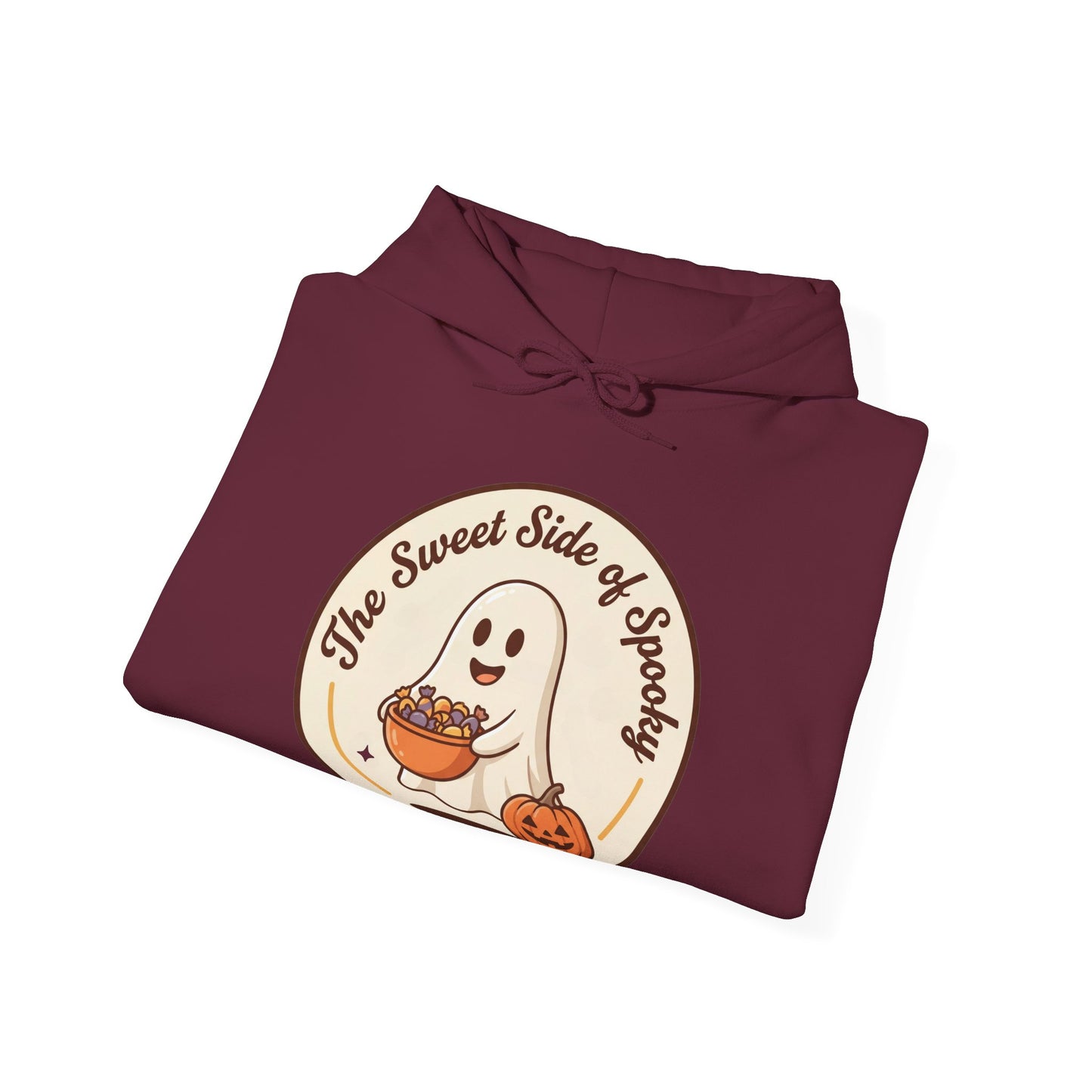 A folded maroon hoodie on a white background, featuring a circular graphic on the front with a cartoon ghost holding a bowl of candy and the text 'The Sweet Side of Spooky' next to a small pumpkin.