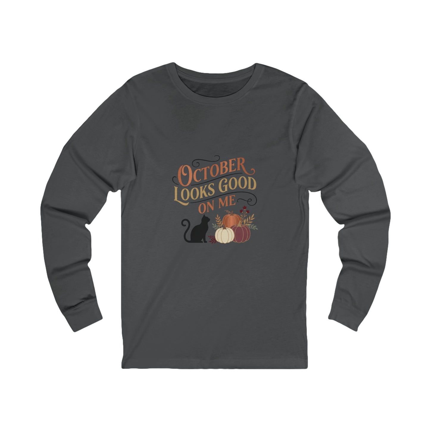 A dark gray long-sleeve t-shirt with a graphic on the chest that reads 'OCTOBER LOOKS GOOD ON ME' in orange and gold lettering, accompanied by a black cat, pumpkins, and autumn leaves, shown on a plain white background.