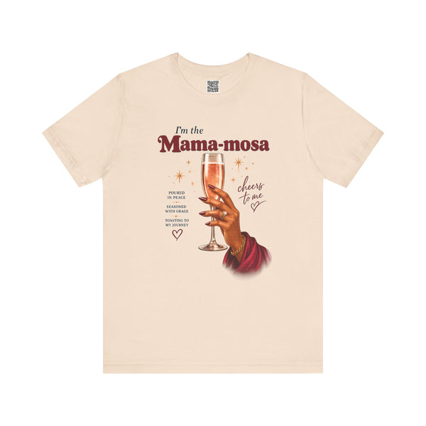 Beige t-shirt with graphic of a hand holding a glass of champagne and text 'I'm the Mama-mosa, cheers to me' on a white background.