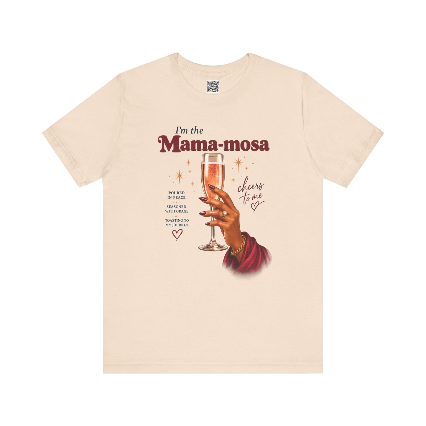 Beige t-shirt with graphic of a hand holding a glass of champagne and text 'I'm the Mama-mosa, cheers to me' on a white background.