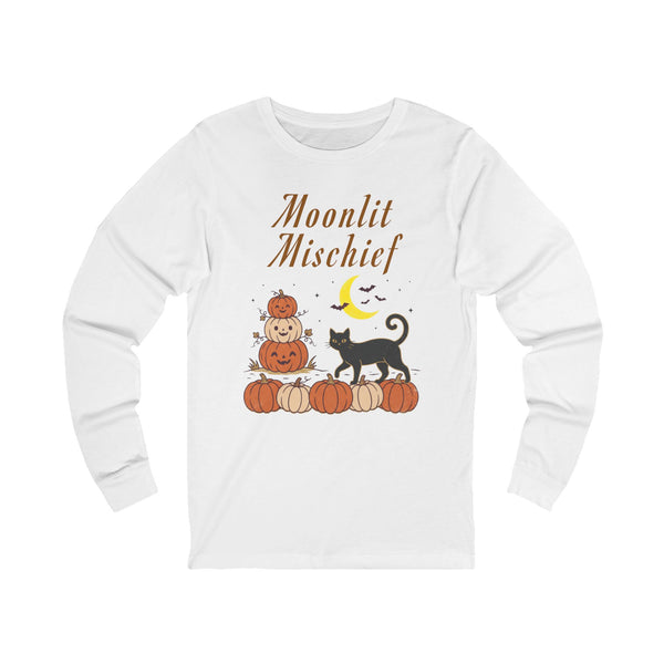 A white long-sleeve t-shirt with a Halloween graphic on the front. The graphic features the text 'Moonlit Mischief' in brown script above a stack of pumpkins with a jack-o'-lantern, a black cat, a yellow crescent moon, and small bats.