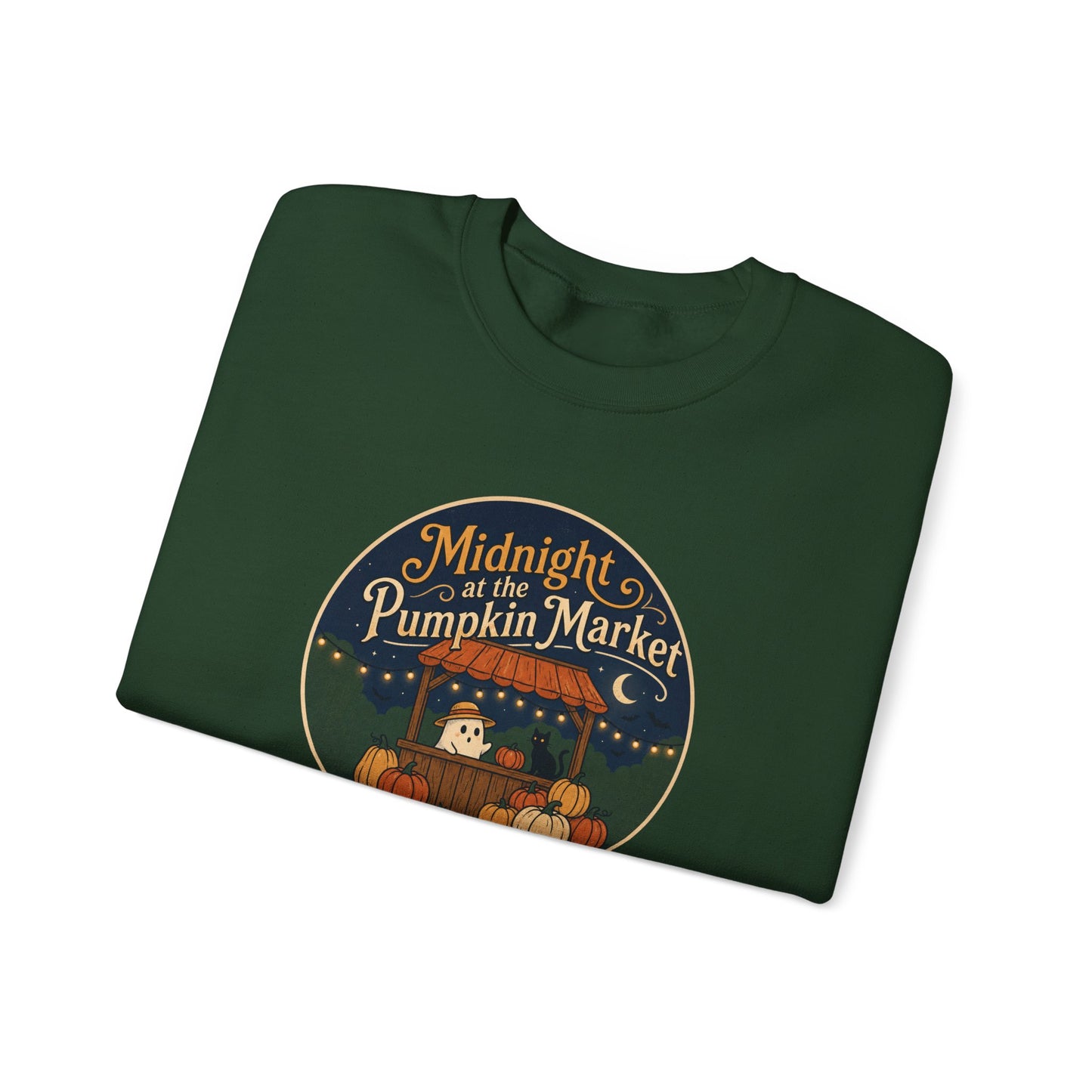 Green graphic sweatshirt folded featuring a 'Midnight Pumpkin Market' design, layered under an olive green jacket. She is standing against a solid white background.
