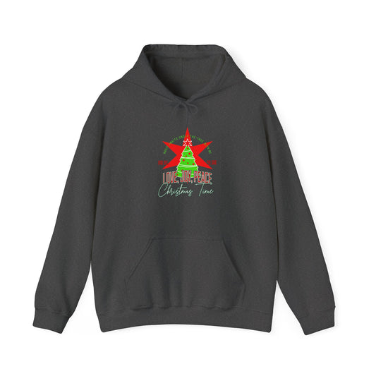 A dark gray hoodie with a Christmas graphic on the chest, featuring a green tree, red star, and the text 'LOVE, JOY, PEACE Christmas Time' on a plain white background.