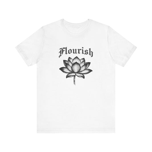 White t-shirt with black lotus flower and 'Flourish' text on a white background
