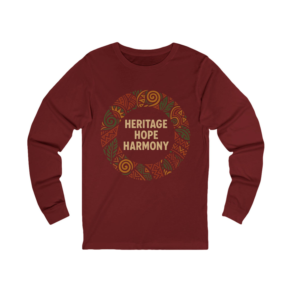A maroon long-sleeve t-shirt with a circular graphic on the chest featuring the words 'HERITAGE HOPE HARMONY' in tan lettering, surrounded by a pattern of orange, green, and brown tribal-style motifs, shown on a plain white background.
