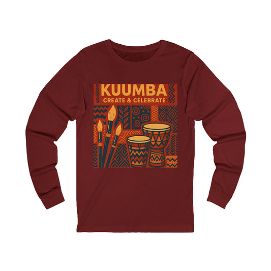 A long-sleeve crewneck t-shirt in maroon, featuring a graphic print on the front with the text 'KUUMBA CREATE & CELEBRATE' and illustrations of African drums and paintbrushes.