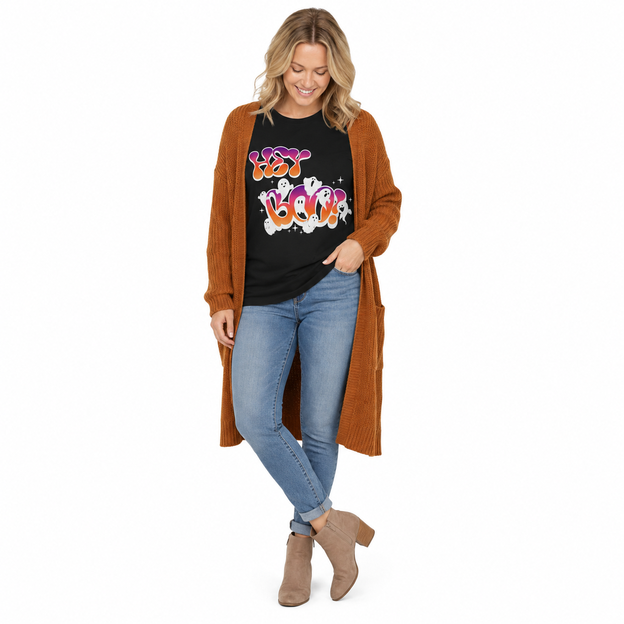A woman modeling a long brown open-front cardigan over a black graphic t-shirt, paired with light blue jeans and taupe ankle boots, on a solid white background.