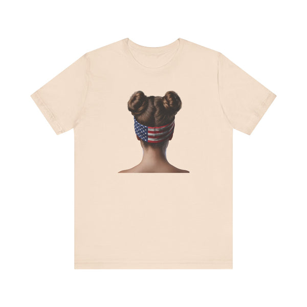 Soft cream t-shirt with a graphic of a person with braided hair wearing an American flag headband on the back.