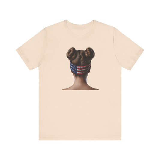 Soft cream t-shirt with a graphic of a person with braided hair wearing an American flag headband on the back.