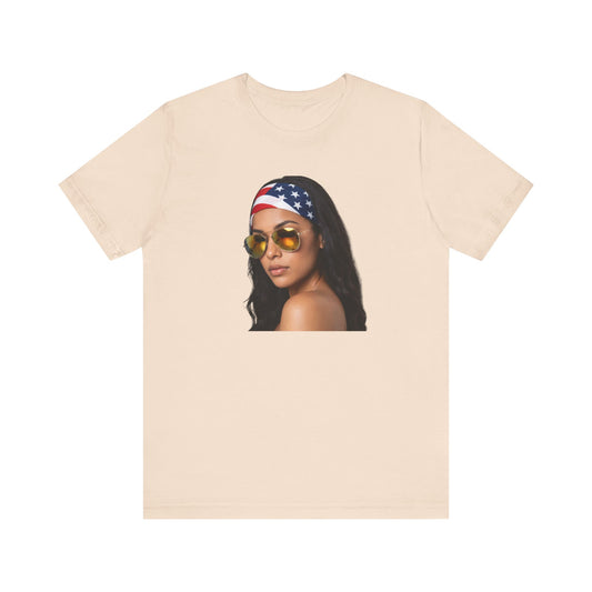 Cream t-shirt with a graphic of a woman wearing sunglasses and an American flag headband on a white background.