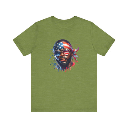 Heather green t-shirt with a graphic of a face wearing an American flag bandana on a white background