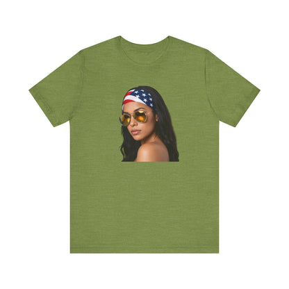 Heather green t-shirt with a graphic of a woman wearing sunglasses and an American flag headband on a white background.